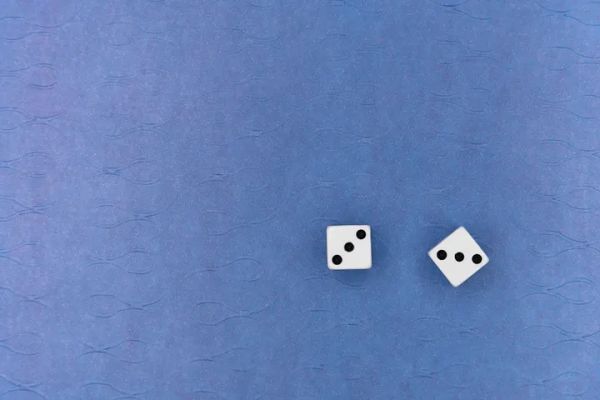 A pair of die, both showing 3 dots on top