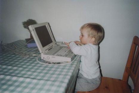 A picture of me around the age of 4 using an early 2000's laptop