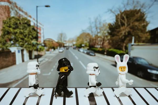 A Lego minifigure with a bunny hat, two Stromtroopers and happy Darth Vader doing a Beatles Abbey Road impression